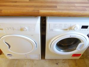 a white washer and dryer under a counter at Haimwood Byetake in Llanymynech