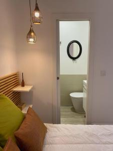 - une chambre avec un lit et une salle de bains avec un miroir dans l'établissement Modern Studio in the Historic Center of Bica, à Lisbonne