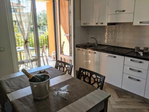 a kitchen with a table with a bucket on it at Il Giglio Marino Cilento Residence by ElodeaGroup in Ascea