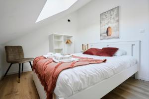 a bedroom with a bed with a red blanket and a chair at Beautiful house at the heart of Lomme nearby Lille center - Welkeys in Lille