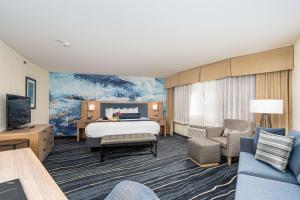 a hotel room with a bed and a couch at Best Western Plus Marina Gateway Hotel in National City