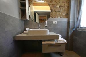 a bathroom with a sink and a mirror at La Casa in Paese in Peschiera del Garda