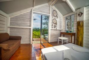 a living room with a couch and a large window at FairyTale in Koukounariá