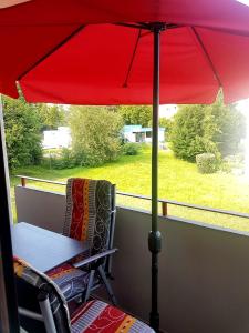 a chair under an umbrella on a porch at Szafranzimmervermmitung in Winnenden