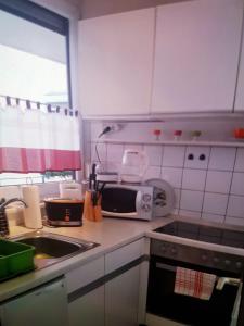 a kitchen with a sink and a stove top oven at Szafranzimmervermmitung in Winnenden