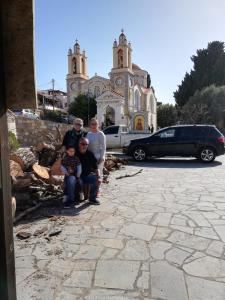 a group of people posing in front of a church at Star Sianna Village Rooms to let in Siána