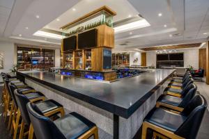a bar in a hotel with chairs around it at Sonesta Denver Downtown in Denver