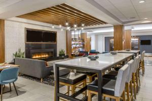 a conference room with a table and chairs and a fireplace at Sonesta Denver Downtown in Denver