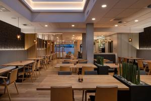 a restaurant with wooden tables and chairs at Hotel Osvit in Mladá Boleslav