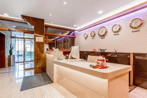 a kitchen with a counter and clocks on the wall at Beausite in Lausanne