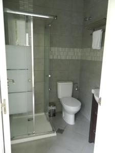 a bathroom with a toilet and a glass shower at Hotel Restaurant Baladrar in Benissa +39 photos