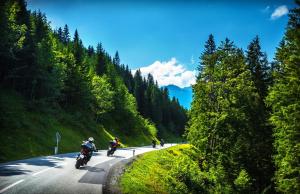 two people riding motorcycles on a mountain road at Hotel Winterberg Resort in Winterberg