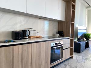 a kitchen with white cabinets and a stove top oven at ICON - Private Holiday Apartments in Limassol +4 photos