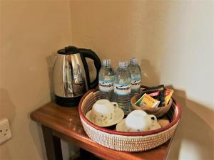 a basket with bottles of water on a table at Kaswa Lodge in Fort Portal