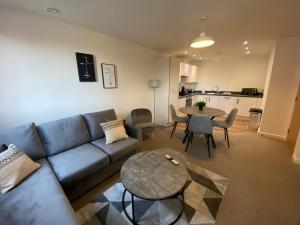 uma sala de estar com um sofá e uma mesa em 2 Bedroom, 2 Bathroom Modern Apartment close to Ocean Village, Free parking, Single or Double beds em Southampton