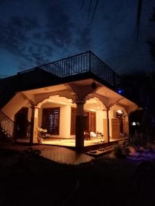 a large house at night with a balcony at Nature View in Batticaloa