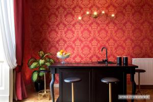 a kitchen with a sink and a red wall at La Casa Sul Nilo in Naples