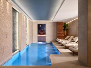 a swimming pool in a room with blue floors at Vista Palazzo in Verona