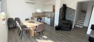 a kitchen with a table and a wood stove at Apartman Lynx on lake Sabljaci in Ogulin