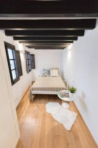 a bedroom with a bed in the middle of a room at Loft en el corazón de palma cerca de la catedral in Palma de Mallorca