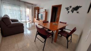 a living room with a table and chairs and a couch at Mar i Angels Apartament in Pineda de Mar