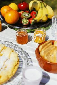 a table topped with a table with fruit and honey at Bed & Breakfast Spigolatrice in Sapri