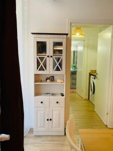 a kitchen with a white cabinet in a room at Maelle Trastevere in Rome