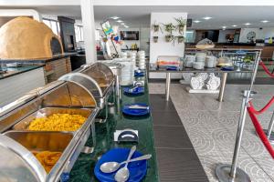 a kitchen with a buffet of food on a counter at Hotel Chicamocha in Bucaramanga