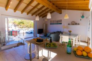 a kitchen and living room with a table with fruit on it at Can MarSal Puerto Valldemosa in Valldemossa