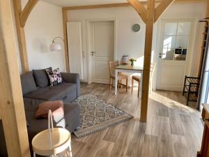 a living room with a couch and a table at Ferienwohnung Hof Falke in Suderbruch