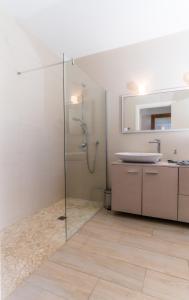 a bathroom with a glass shower and a sink at Can MarSal Puerto Valldemosa in Valldemossa