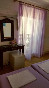 a bedroom with two beds and a mirror and a dresser at Rooms Milena in Lopud