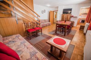 a living room with a table and a dining room at Apartments Rombon Klavdij with Free Onsite Parking in Bovec