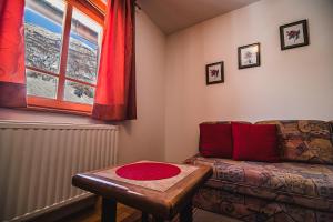 a living room with a couch and a table at Apartments Rombon Klavdij with Free Onsite Parking in Bovec +10 photos