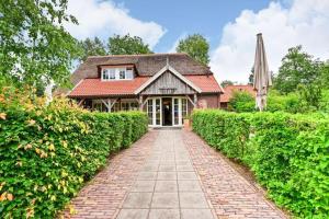 a house with a brick walkway in front of a building at Safari Retreat "Explorer Tents" in Holten +19 photos
