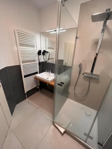 a bathroom with a shower and a sink at Hotel-Restaurant Amadeus in Hannover