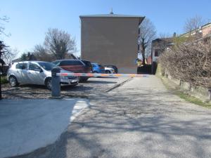 two cars parked in a parking lot with a caution tape at Studio apartman Jordanovac Rebro in Zagreb