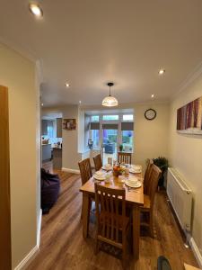 a dining room and living room with a table and chairs at The Homestead House in Doncaster