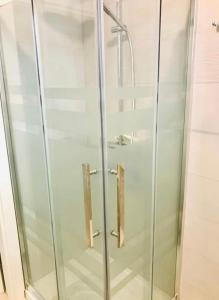 a shower with glass doors in a bathroom at Villa“La Salentina” in Castrignano del Capo