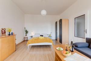 a living room with a bed and a couch at Sunshine Apartment near the City center in Prague +33 photos