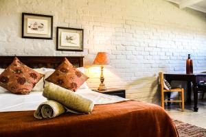 a bed with a stuffed animal laying on top of it at Gerald's Gift Guest House in Addo