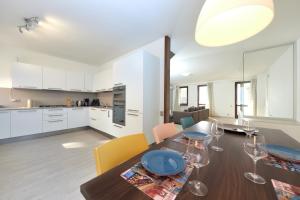 a kitchen and dining room with a table and chairs at Lake Front Casa Christina in Malcesine