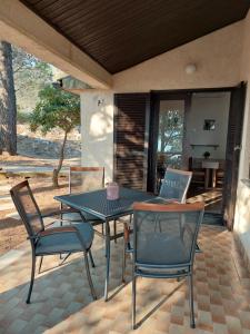 a patio with a table and chairs with a laptop on it at Gavza Joy in Cres
