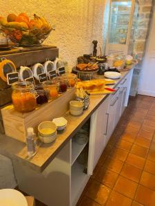 a kitchen with a counter with food on it at Hôtel La Bastide de Vaison in Vaison-la-Romaine