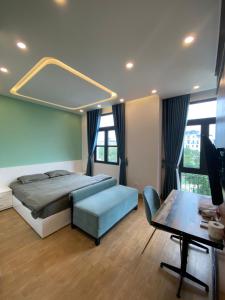 a bedroom with a large bed and a table at Vinhomes Imperia in Hai Phong