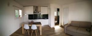 a living room with a couch and a table and chairs at La casa dei fichi in Porto Azzurro