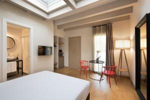 a bedroom with a bed and a table and chairs at Opera35 Boutique Hotel in Turin
