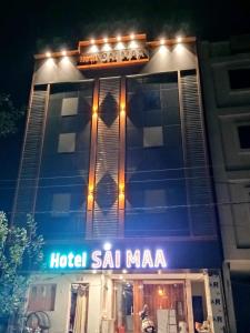 a hotel salmiya is lit up at night at Hotel Sai Maa in Shirdi