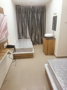a room with a bed and a window in it at Hotel Sai Maa in Shirdi