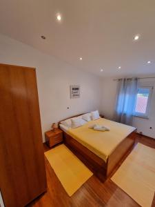 Postel nebo postele na pokoji v ubytování Apartments Vukic